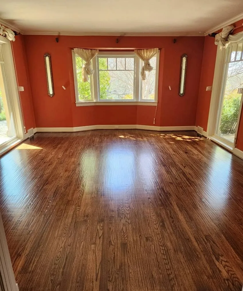 Refinished dark oak hardwood flooring in a sitting room with bay window, Dallas Fort Worth TX
